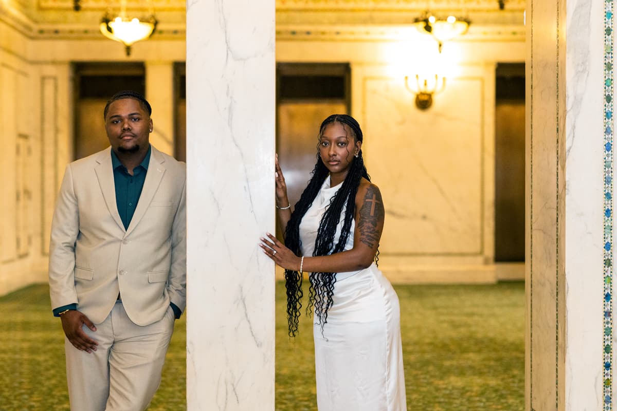 Karmyn and Anthony by marble columns