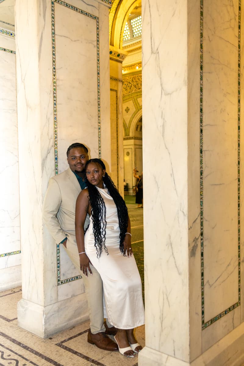 Anthony and Karmyn leaning on columns